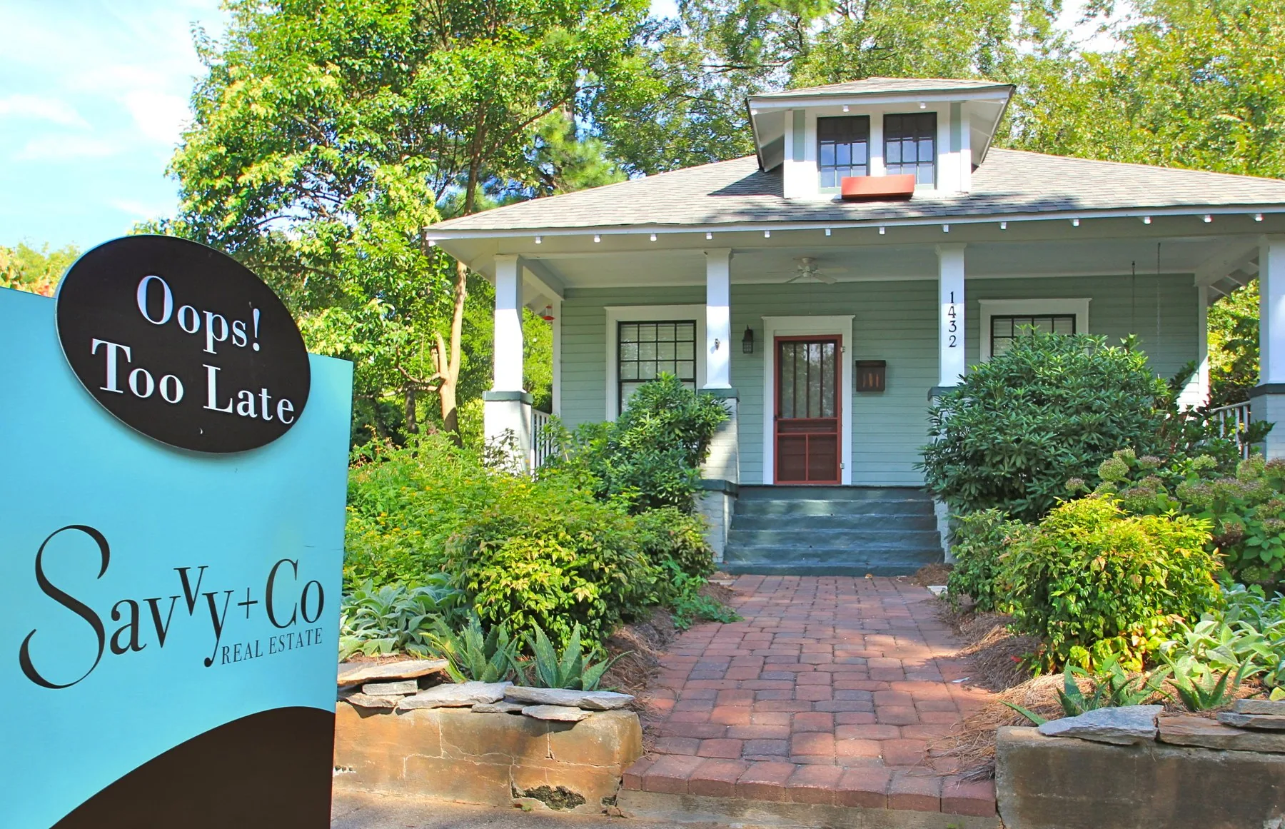 A Savvy + Co. &ldquo;Oops! Too Late&rdquo; sign outside a Charlotte bungalow